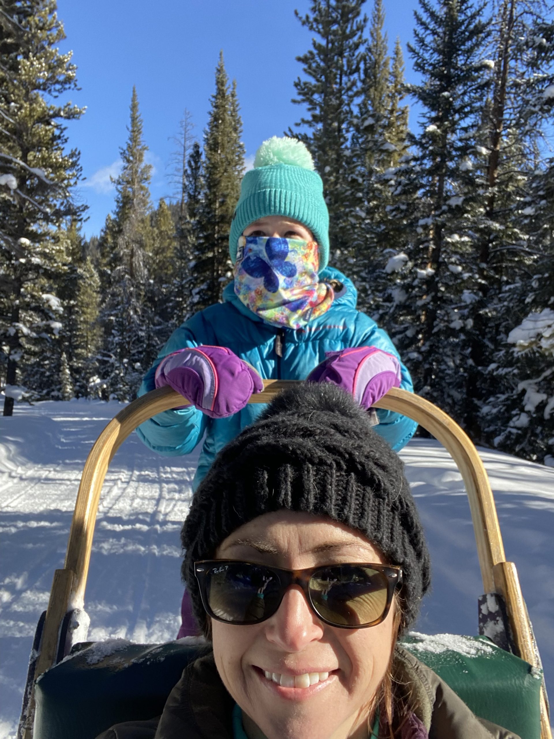 Sydney driving Lauren on sled